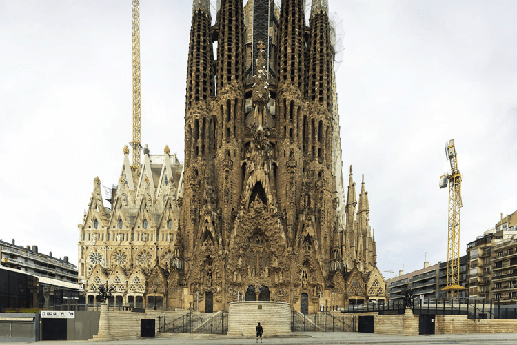 The intricate facade of the Sagrada Família in Barcelona, showcasing its unique Gothic and Art Nouveau architectural elements, with towering spires and detailed sculptures.