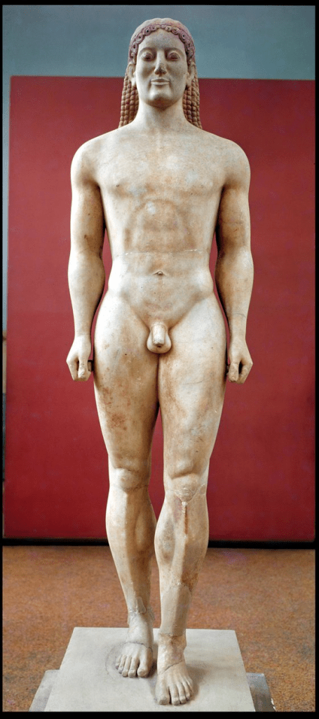 A statue of a kouros, an ancient Greek representation of a youthful male figure, standing upright with arms at the sides, showcasing idealized human proportions and details.