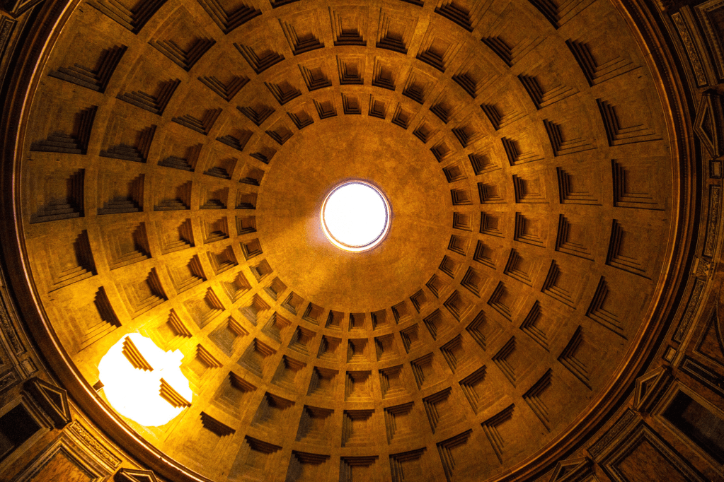 Interior view of the Pantheon dome in Rome, showcasing the coffered ceiling and the central oculus, illuminated by natural light.