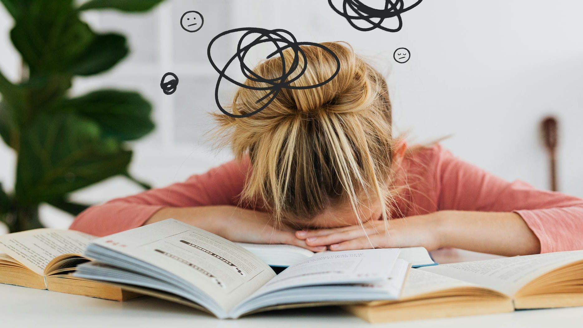 A person with blonde hair resting their head on a table covered with open books, surrounded by doodles representing confusion or frustration.